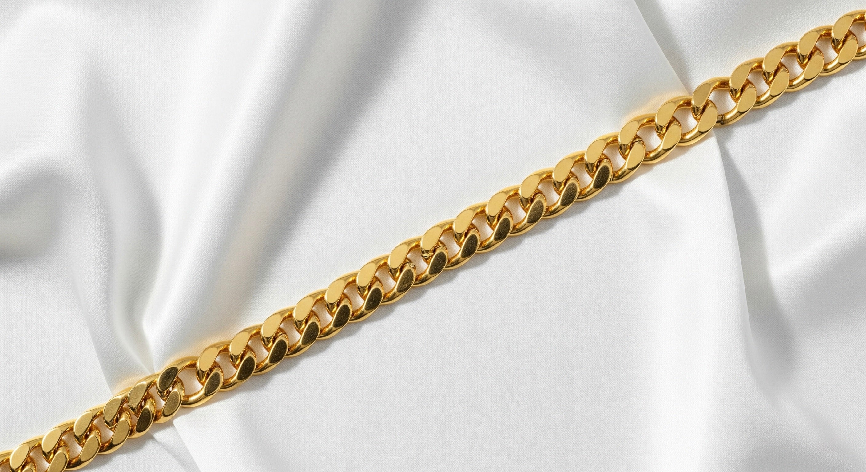 Gold chain on a white fabric background
